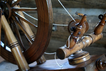 This photo of an antique spinning wheel (technically a flax wheel) was taken by Gary Scott of Cambridge, Canada.